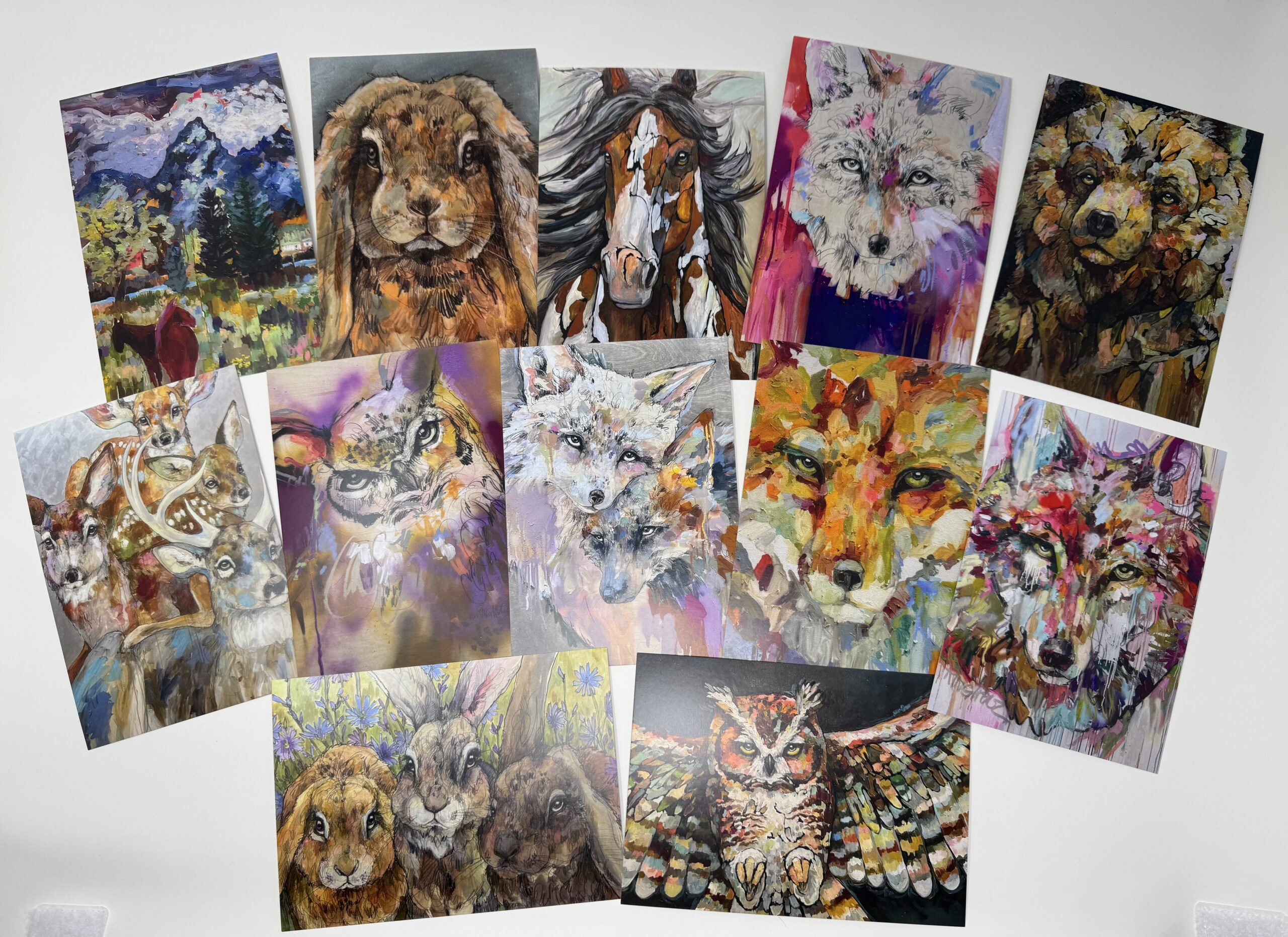 Colorful animal paintings arranged on white background
