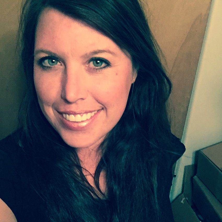 A  woman  in  a  black  shirt  is  taking  a  selfie.