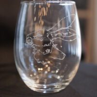 An ETCHED STEMLESS WINE GLASS SET with a drawing of a rabbit on it.