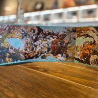 A BOUNDLESS GATE CARD with illustrations on it sitting on a table.