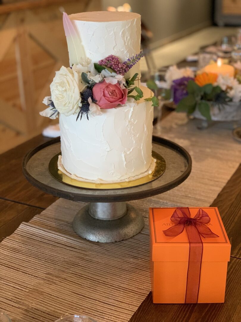 Two-tier wedding cake with flowers.