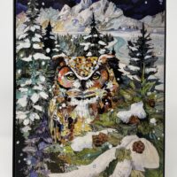 Snowy owl in winter mountain scene.